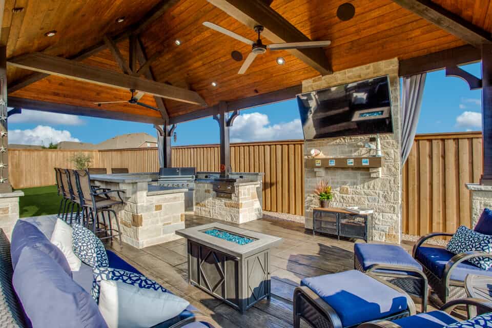 Custom outdoor covered patio with fireplace and outdoor kitchen